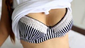 lifts shirt and showing bra