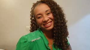 Beautiful curly-haired Ebony Booty Call smiles