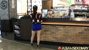 Cute Asian girl in short skirt at the mall after a car show