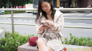 Cute Taiwanese texting on her phone