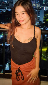 Maria C posing on balcony in dress and tight revealing top