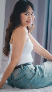 Micky sits pretty in nice jeans with ass side view