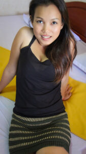Pretty Cambodian Sok Neng sits in sexy dress